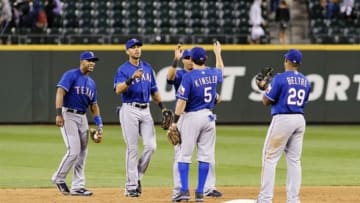 Aug 27, 2013; Seattle, WA, USA; The Texas Rangers celebrate after defeating the Seattle Mariners in the 10th inning at Safeco Field. Texas defeated Seattle 4-3. Mandatory Credit: Steven Bisig-USA TODAY Sports