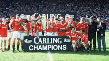 MANCHESTER, ENGLAND - MAY 8: The Manchester United team celebrate on the pitch with the Premiership Trophy after becoming FA Carling Premiership Winners in the 1993-94 season at Old Trafford on May 8, 1994. Manchester United 0 Coventry City 0. (Photo by John Peters/Manchester United via Getty Images)
