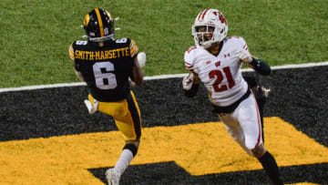 Dec 12, 2020; Iowa City, Iowa, USA; Iowa Hawkeyes wide receiver Ihmir Smith-Marsette (6) catches a touchdown pass from quarterback Spencer Petras (not pictured) as Wisconsin Badgers cornerback Caesar Williams (21) defends during the third quarter at Kinnick Stadium. Mandatory Credit: Jeffrey Becker-USA TODAY Sports