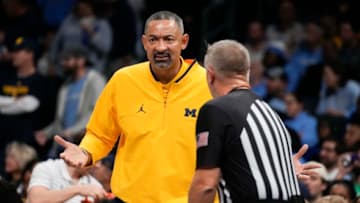 Dec 21, 2022; Charlotte, North Carolina, USA; Michigan Wolverines head coach Juwan Howard talks with an official during the first half against the North Carolina Tar Heels at the Jumpman Classic at the Spectrum Center. Mandatory Credit: Jim Dedmon-USA TODAY Sports