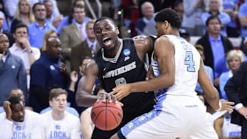 Mar 19, 2016; Raleigh, NC, USA; Providence Friars forward Ben Bentil (0) dribbles the ball as North Carolina Tar Heels forward Isaiah Hicks (4) defends in the first half during the second round of the 2016 NCAA Tournament at PNC Arena. Mandatory Credit: Bob Donnan-USA TODAY Sports