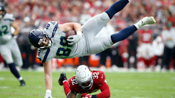 GLENDALE, ARIZONA - SEPTEMBER 29: Tight end Will Dissly #88 of the Seattle Seahawks is up-ended by safety Budda Baker #32 of the Arizona Cardinals after a catch during the first half of the NFL football game at State Farm Stadium on September 29, 2019 in Glendale, Arizona. (Photo by Ralph Freso/Getty Images)