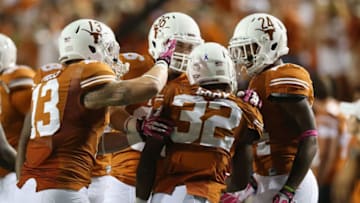 AUSTIN, TX - SEPTEMBER 21: Johnathan Gray #32 of the Texas Longhorns celebrates his touchdown with Chet Moss #13, Alex De La Torre #36 and Joe Bergeron #24 of the Texas Longhorns during play against the Kansas State Wildcats at Darrell K Royal-Texas Memorial Stadium on September 21, 2013 in Austin, Texas. (Photo by Ronald Martinez/Getty Images)