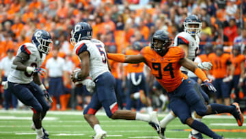 SYRACUSE, NY - SEPTEMBER 22: Alton Robinson #94 of the Syracuse Orange pressures David Pindell #5 of the Connecticut Huskies during the first quarter at the Carrier Dome on September 22, 2018 in Syracuse, New York. (Photo by Rich Barnes/Getty Images)