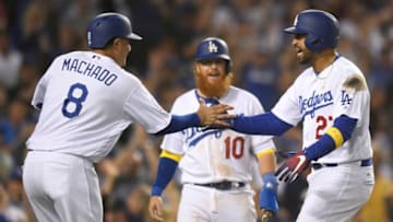 LOS ANGELES, CA - SEPTEMBER 01: Manny Machado #8 of the Los Angeles Dodgers and Justin Turner #10 welcome Matt Kemp #27 Dodgers home after a 3 run home run against the Arizona Diamondbacks in the eighth inning at Dodger Stadium on September 1, 2018 in Los Angeles, California. (Photo by John McCoy/Getty Images) ***Manny Machado; Justin Turner; Matt Kemp
