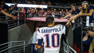 Sep 11, 2016; Glendale, AZ, USA; New England Patriots quarterback Jimmy Garoppolo (10) celebrates with fans as he leaves the field after defeating the Arizona Cardinals at University of Phoenix Stadium. The Patriots defeated the Cardinals 23-21. Mandatory Credit: Mark J. Rebilas-USA TODAY Sports
