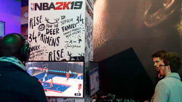 PARIS, FRANCE - OCTOBER 25: Gamers play the video game 'NBA 2K19' developed by Visual Concepts and published by 2K Sports during the 'Paris Games Week' on October 25, 2018 in Paris, France. 'Paris Games Week' is an international trade fair for video games and runs from October 26 to 31, 2018. (Photo by Chesnot/Getty Images)