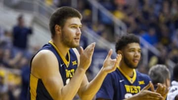 Feb 22, 2016; Morgantown, WV, USA; West Virginia Mountaineers forward Nathan Adrian (11) celebrates from the bench during the second half against the Iowa State Cyclones at the WVU Coliseum. Mandatory Credit: Ben Queen-USA TODAY Sports