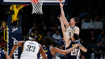 Nov 10, 2021; Denver, Colorado, USA; Indiana Pacers guard T.J. McConnell (9) drives to the net against Denver Nuggets guard Austin Rivers (25) as forward Zeke Nnaji (22) and center Myles Turner (33) defend in the third quarter at Ball Arena. Mandatory Credit: Isaiah J. Downing-USA TODAY Sports