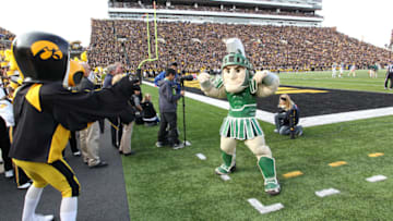 IOWA CITY, IA - NOVEMBER 12: Herky the mascot of the Iowa Hawkeyes battles with Sparty of the Michigan State Spartans before kickoff at Kinnick Stadium November 12, 2011 in Iowa City, Iowa. Michigan State beat Iowa 37-21. (Photo by Reese Strickland/Getty Images)