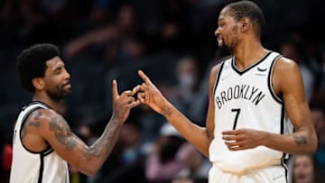 CHARLOTTE, NORTH CAROLINA - MARCH 08: (L-R) Kyrie Irving #11 of the Brooklyn Nets celebrates with Kevin Durant #7 during their game against the Charlotte Hornets at Spectrum Center on March 08, 2022 in Charlotte, North Carolina. NOTE TO USER: User expressly acknowledges and agrees that, by downloading and or using this photograph, User is consenting to the terms and conditions of the Getty Images License Agreement. (Photo by Jacob Kupferman/Getty Images)