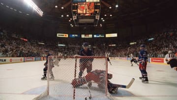7 Jun 1994: RANGERS DEFENSEMAN BRIAN LEETCH CLEARS THE PUCK FROM THE BACK OF THE NET AS THE CANUCKS CELEBRATE AFTER CLIFF RONNING''S FIRST PERIOD GOAL TONIGHT OF GAME FOUR OF THE STANLEY CUP FINALS AT THE PACIFIC COLISEUM IN VANCOUVER, BRITISH COLUMBIA. RO