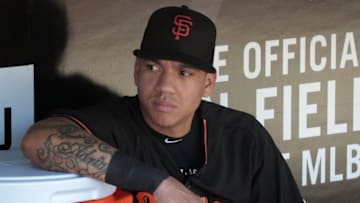 Jun 21, 2016; Pittsburgh, PA, USA; San Francisco Giants shortstop Ehire Adrianza (13) looks on from the dugout before the game against the Pittsburgh Pirates at PNC Park. Mandatory Credit: Charles LeClaire-USA TODAY Sports