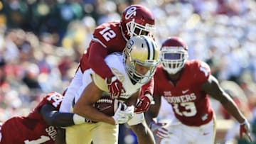 Nov 12, 2016; Norman, OK, USA; Oklahoma Sooners defensive back Will Johnson (12) and linebacker Emmanuel Beal (14) tackle Baylor Bears wide receiver Blake Lynch (2) during the second quarter at Gaylord Family - Oklahoma Memorial Stadium. Mandatory Credit: Kevin Jairaj-USA TODAY Sports