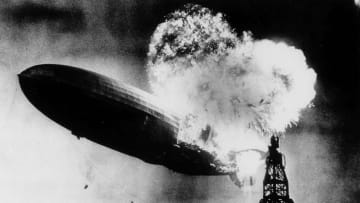 LZ-129 Hindenburg, a rigid airship manufactured in Germany by the Zeppelin Company, catches fire as it comes in for a landing in Lakehurst, New Jersey, on May 6, 1937.