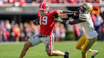 Nov 26, 2022; Athens, Georgia, USA; Georgia Bulldogs tight end Brock Bowers (19) is called for a facemark penalty as he runs against Georgia Tech Yellow Jackets defensive back Zamari Walton (7) during the first half at Sanford Stadium. Mandatory Credit: Dale Zanine-USA TODAY Sports