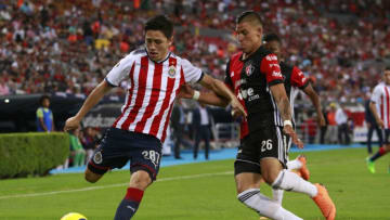 GUADALAJARA, MEXICO - APRIL 20: Oscar Macias (L) of Chivas and Cristian Calderon (R) of Atlas compete for the ball during the 16th round match between Atlas and Chivas as part of the Torneo Clausura 2018 Liga MX at Jalisco Stadium on April 13, 2018 in Guadalajara, Mexico. (Photo by Juan Mejia/Jam Media/Getty Images)
