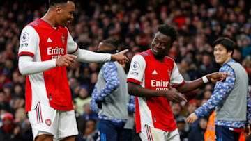 Arsenal's English midfielder Bukayo Saka (2nd R) dances with Arsenal's Brazilian defender Gabriel (L) as he celebrates scoring their second goal during the English Premier League football match between Arsenal and Brentford at the Emirates Stadium in London on February 19, 2022. - - RESTRICTED TO EDITORIAL USE. No use with unauthorized audio, video, data, fixture lists, club/league logos or 'live' services. Online in-match use limited to 120 images. An additional 40 images may be used in extra time. No video emulation. Social media in-match use limited to 120 images. An additional 40 images may be used in extra time. No use in betting publications, games or single club/league/player publications. (Photo by Ian KINGTON / AFP) / RESTRICTED TO EDITORIAL USE. No use with unauthorized audio, video, data, fixture lists, club/league logos or 'live' services. Online in-match use limited to 120 images. An additional 40 images may be used in extra time. No video emulation. Social media in-match use limited to 120 images. An additional 40 images may be used in extra time. No use in betting publications, games or single club/league/player publications. / RESTRICTED TO EDITORIAL USE. No use with unauthorized audio, video, data, fixture lists, club/league logos or 'live' services. Online in-match use limited to 120 images. An additional 40 images may be used in extra time. No video emulation. Social media in-match use limited to 120 images. An additional 40 images may be used in extra time. No use in betting publications, games or single club/league/player publications. (Photo by IAN KINGTON/AFP via Getty Images)