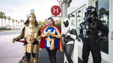 SAN DIEGO, CALIFORNIA - JULY 22: (L-R) Cosplayers Christopher Canole as Dude Vader, Faeren Adams as Dr. Strange, Derek Shackelton as Moon Knight, and Todd Felton as a TIE Pilot pose in front of Hall H at San Diego Convention Center on July 22, 2020 in San Diego, California. 2020 Comic-Con International will occur as a virtual event, Comic-Con@Home, due to the coronavirus epidemic. (Photo by Daniel Knighton/Getty Images)