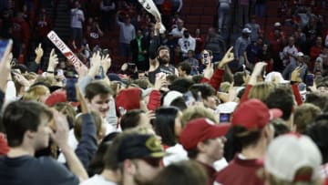 Jan 28, 2023; Norman, Oklahoma, USA; Oklahoma Sooners forward Tanner Groves (middle) celebrates with fans on the court after defeating the Alabama Crimson Tide during the first half at Lloyd Noble Center. Mandatory Credit: Alonzo Adams-USA TODAY Sports