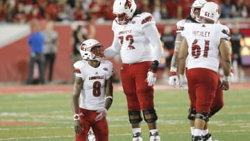 HOUSTON, TX - NOVEMBER 17: Offensive lineman Lukayus McNeil #72 comforts quarterback Lamar Jackson #8 of the Louisville Cardinals after being sacked by the Houston Cougars in the third quarter at TDECU Stadium on November 17, 2016 in Houston, Texas. Houston Cougars won 36 to 10. (Photo by Thomas B. Shea/Getty Images)
