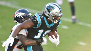 Dec 13, 2020; Charlotte, North Carolina, USA; Carolina Panthers wide receiver Curtis Samuel (10) with the ball as Denver Broncos safety Will Parks (27) defends in the third quarter at Bank of America Stadium. Mandatory Credit: Bob Donnan-USA TODAY Sports