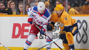 NASHVILLE, TN - DECEMBER 29: Ryan Ellis #4 of the Nashville Predators battles for the puck against Vladislav Namestnikov #90 of the New York Rangers at Bridgestone Arena on December 29, 2018 in Nashville, Tennessee. (Photo by John Russell/NHLI via Getty Images)