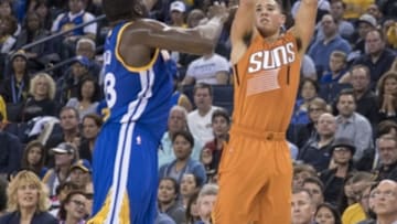 November 13, 2016; Oakland, CA, USA; Phoenix Suns guard Devin Booker (1) shoots the basketball against Golden State Warriors forward Draymond Green (23) during the third quarter at Oracle Arena. The Warriors defeated the Suns 133-120. Mandatory Credit: Kyle Terada-USA TODAY Sports