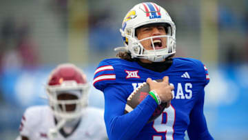 LAWRENCE, KANSAS - OCTOBER 28: Jason Bean #9 of the Kansas Jayhawks runs past Kendel Dolby #15 of the Oklahoma Sooners for a touchdown during the second half at David Booth Kansas Memorial Stadium on October 28, 2023 in Lawrence, Kansas. (Photo by Jay Biggerstaff/Getty Images)