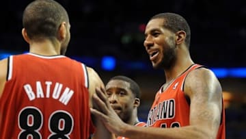 Dec 31, 2013; Oklahoma City, OK, USA; Portland Trail Blazers power forward LaMarcus Aldridge (12) congratulates small forward Nicolas Batum (88) in action against the Oklahoma City Thunder at Chesapeake Energy Arena. Mandatory Credit: Mark D. Smith-USA TODAY Sports