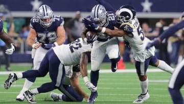 ARLINGTON, TEXAS - DECEMBER 15: Ezekiel Elliott #21 of the Dallas Cowboys gets hit by Tanzel Smart #92 and Dante Fowler #56 of the Los Angeles Rams at AT&T Stadium on December 15, 2019 in Arlington, Texas. (Photo by Richard Rodriguez/Getty Images)