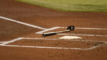 PHOENIX, ARIZONA - SEPTEMBER 13: A detail of a bat and elbow guard laying next to home plate during a game between the Arizona Diamondbacks and the Seattle Mariners at Chase Field on September 13, 2020 in Phoenix, Arizona. (Photo by Norm Hall/Getty Images)