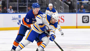Mar 7, 2023; Elmont, New York, USA; Buffalo Sabres center Tyson Jost (17) skates with the puck chased by New York Islanders right wing Simon Holmstrom (10) during the second period at UBS Arena. Mandatory Credit: Dennis Schneidler-USA TODAY Sports