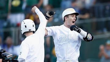 OAKLAND, CALIFORNIA - AUGUST 24: Mark Canha #20 of the Oakland Athletics celebrates after hitting a solo home run in the bottom of the second inning against the San Francisco Giants at Ring Central Coliseum on August 24, 2019 in Oakland, California. Teams are wearing special color schemed uniforms with players choosing nicknames to display for Players' Weekend. (Photo by Lachlan Cunningham/Getty Images)