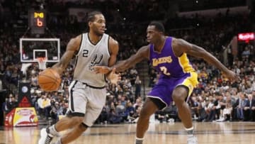 Feb 6, 2016; San Antonio, TX, USA; San Antonio Spurs small forward Kawhi Leonard (2) drives against Los Angeles Lakers power forward Brandon Bass (2) during the second half at AT&T Center. Mandatory Credit: Soobum Im-USA TODAY Sports