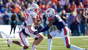 Auburn footballDec 28, 2021; Birmingham, Alabama, USA; Houston Cougars wide receiver Jake Herslow (87) is tackled by Auburn Tigers linebacker Chandler Wooten (31) and Auburn Tigers linebacker Cam Riley (35) during the first half of the 2021 Birmingham Bowl at Protective Stadium. Mandatory Credit: Marvin Gentry-USA TODAY Sports