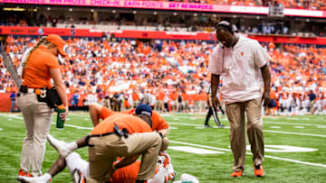 SYRACUSE, NY - SEPTEMBER 21: Head coach Dino Babers of the Syracuse Orange checks on Antwan Cordy #8 after a big collision during the second half against the Western Michigan Broncos at the Carrier Dome on September 21, 2019 in Syracuse, New York. Syracuse defeats Western Michigan 52-33. (Photo by Brett Carlsen/Getty Images)