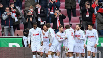Cologne's players celebrate after Cologne's French forward Anthony Modeste (L) scored during the German first division Bundesliga football match between FC Cologne and SC Freiburg in Cologne on February 5, 2022. - DFL REGULATIONS PROHIBIT ANY USE OF PHOTOGRAPHS AS IMAGE SEQUENCES AND/OR QUASI-VIDEO (Photo by Ina Fassbender / AFP) / DFL REGULATIONS PROHIBIT ANY USE OF PHOTOGRAPHS AS IMAGE SEQUENCES AND/OR QUASI-VIDEO (Photo by INA FASSBENDER/AFP via Getty Images)