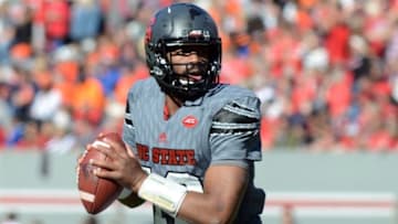 Nov 21, 2015; Raleigh, NC, USA; North Carolina State Wolfpack quarterback Jacoby Brissett (12) looks to pass during the first half against the Syracuse Orange at Carter Finley Stadium. Mandatory Credit: Rob Kinnan-USA TODAY Sports