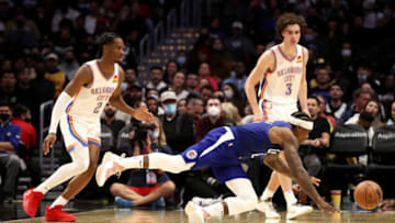 Eric Bledsoe #12 of the Los Angeles Clippers dives for the ball against Shai Gilgeous-Alexander #2 and Josh Giddey #3 of the Oklahoma City Thunder during the fourth quarter at Staples Center on November 01, 2021 in Los Angeles, California. NOTE TO USER: User expressly acknowledges and agrees that, by downloading and/or using this Photograph, user is consenting to the terms and conditions of the Getty Images License Agreement. (Photo by Katelyn Mulcahy/Getty Images)