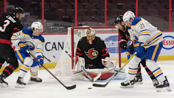 Jan 18, 2022; Ottawa, Ontario, CAN; Ottawa Senators goalie Anton Forsberg (31) follows the puck as Buffalo Sabres left wing Peyton Krebs (19) and right wing Kyle Okposo (21) attack in the first period at the Canadian Tire Centre. Mandatory Credit: Marc DesRosiers-USA TODAY Sports