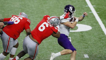 Ohio State Buckeyes defensive tackle Taron Vincent (6) tries to tackle Northwestern Wildcats quarterback Peyton Ramsey (12) during the third quarter of the Big Ten Championship football game at Lucas Oil Stadium in Indianapolis on Saturday, Dec. 19, 2020. Ohio State won 22-10.Big Ten Championship Ohio State Northwestern