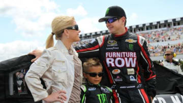 Aug 4, 2013; Long Pond, PA, USA; NASCAR Sprint Cup Series driver Kurt Busch (right) along with his girlfriend Patricia Driscoll (left) and her son Houston Driscoll (middle) prior to the GoBowling.com 400 at Pocono Raceway. Mandatory Credit: Matthew O