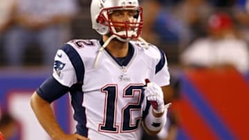 Aug 28, 2014; East Rutherford, NJ, USA; New England Patriots quarterback Tom Brady (12) jogs off the field against the New York Giants during the second quarter at MetLife Stadium. Mandatory Credit: Adam Hunger-USA TODAY Sports