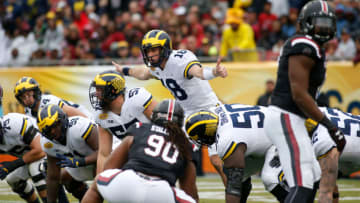 TAMPA, FL - JANUARY 1: Quarterback Brandon Peters #18 of the Michigan Wolverines controls the offense during the first quarter of the Outback Bowl NCAA college football game against the South Carolina Gamecocks on January 1, 2018 at Raymond James Stadium in Tampa, Florida. (Photo by Brian Blanco/Getty Images)