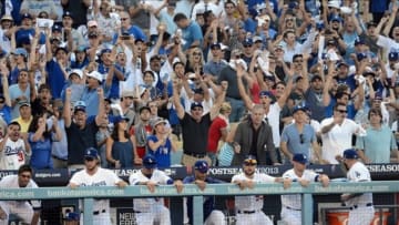 October 16, 2013; Los Angeles, CA, USA; Los Angeles Dodgers fans celebrate the 6-4 victory against the St. Louis Cardinals in game five of the National League Championship Series baseball game at Dodger Stadium. Mandatory Credit: Jayne Kamin-Oncea-USA TODAY Sports
