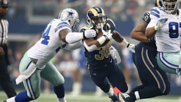 Sep 22, 2013; Arlington, TX, USA; St. Louis Rams running back Benny Cunningham (36) is tackled by Dallas Cowboys defensive end DeMarcus Ware (94) in the first quarter at AT