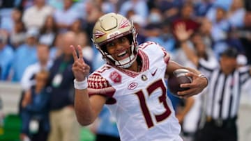 Oct 9, 2021; Chapel Hill, North Carolina, USA; Florida State Seminoles quarterback Jordan Travis (13) runs for a touchdown against the North Carolina Tar Heels during the first half at Kenan Memorial Stadium. Mandatory Credit: James Guillory-USA TODAY Sports