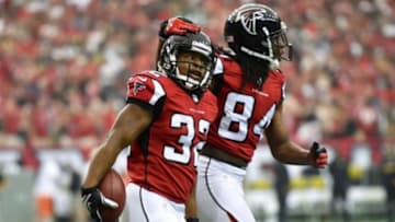 Sep 7, 2014; Atlanta, GA, USA; Atlanta Falcons running back Jacquizz Rodgers (32) reacts with wide receiver Roddy White (84) after scoring a touchdown against the New Orleans Saints during the fourth quarter at the Georgia Dome. The Falcons defeated the Saints 37-34 in overtime. Mandatory Credit: Dale Zanine-USA TODAY Sports