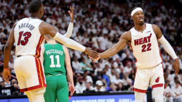 Jimmy Butler #22 of the Miami Heat high-fives his teammate Bam Adebayo #13 against the Boston Celtics(Photo by Michael Reaves/Getty Images)